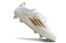 BOTA DE FUTBOL ADIDAS F50 SG ELITE - BLANCO/DORADA